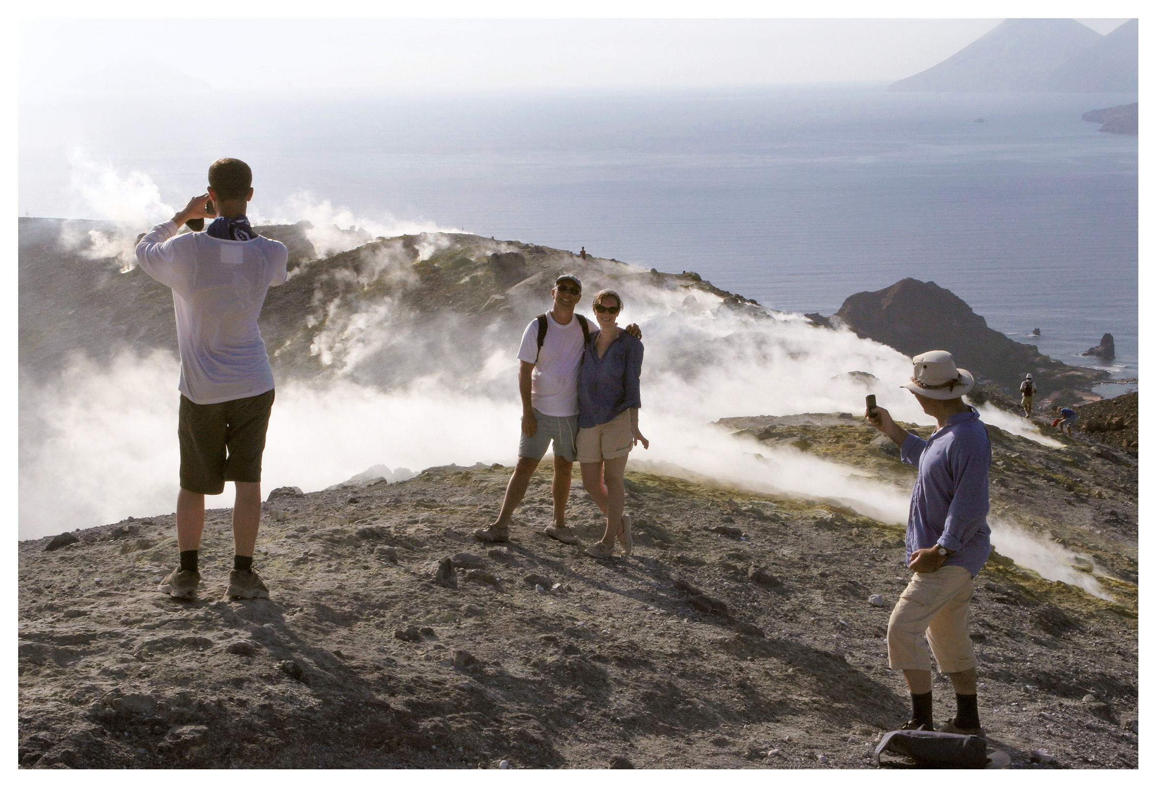 People taking pictures by the steamy crater at Vulcano, Aeolian islands, Sicily