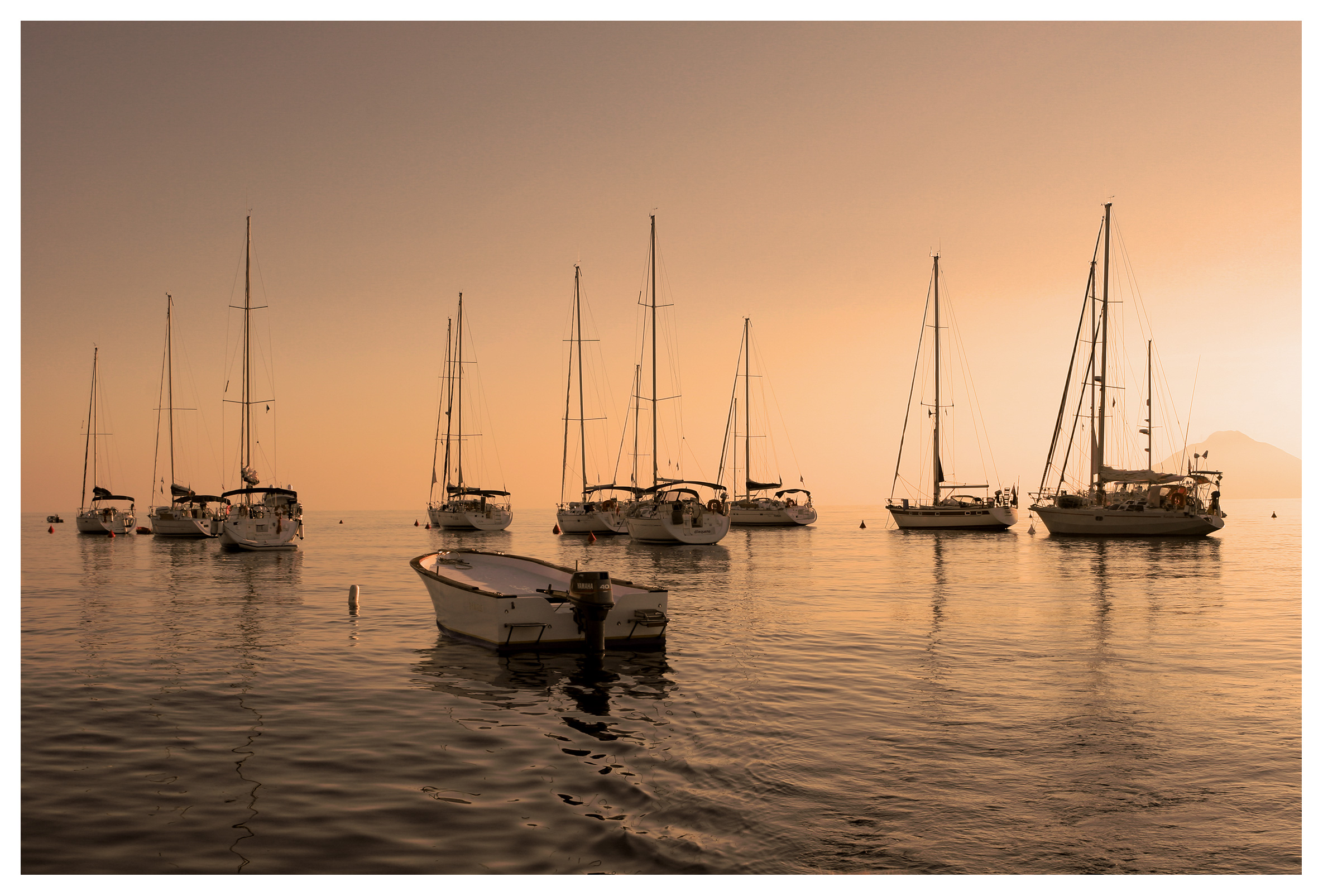 Yachting photography: Sailing yachts moored in the sunset off Panarea, Aeolian islands, Sicily