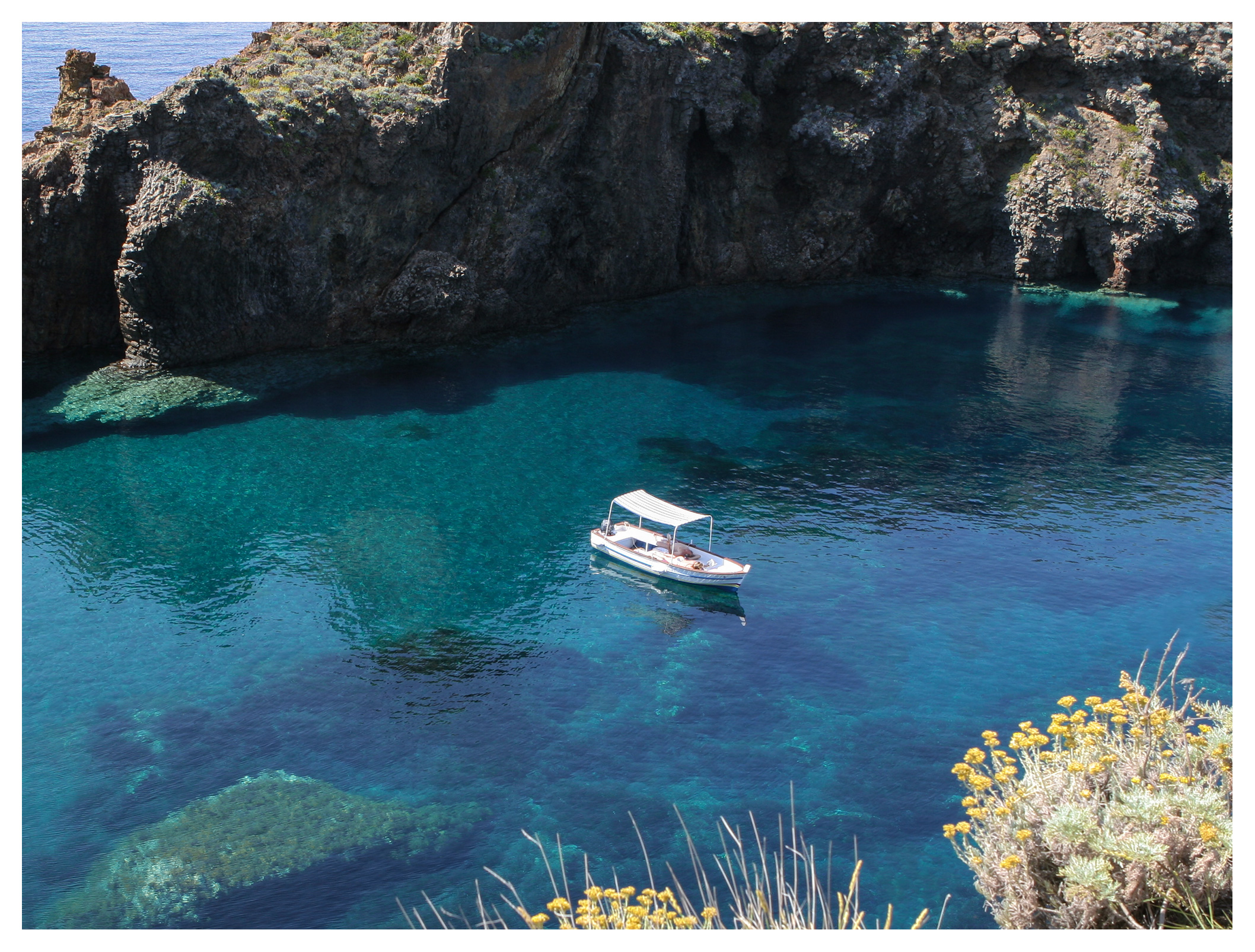 Little boat in crystal clear water, Panarea, Aeolian islands, Sicily