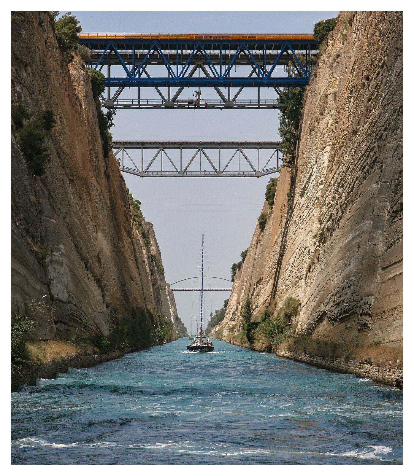 Yachting photography: A sailing yacht negotiating its way through the Corinth Canal, Greece