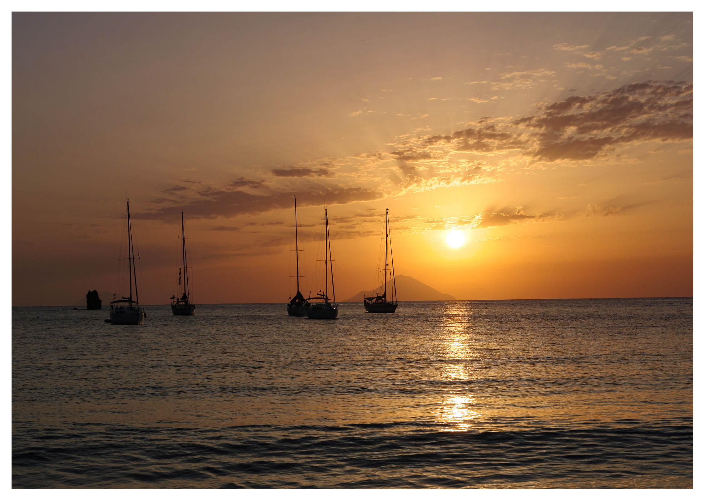 Yachting photography: Yachts anchored in a glorious sunset off Vulcano at the Aeolian Islands, Sicily